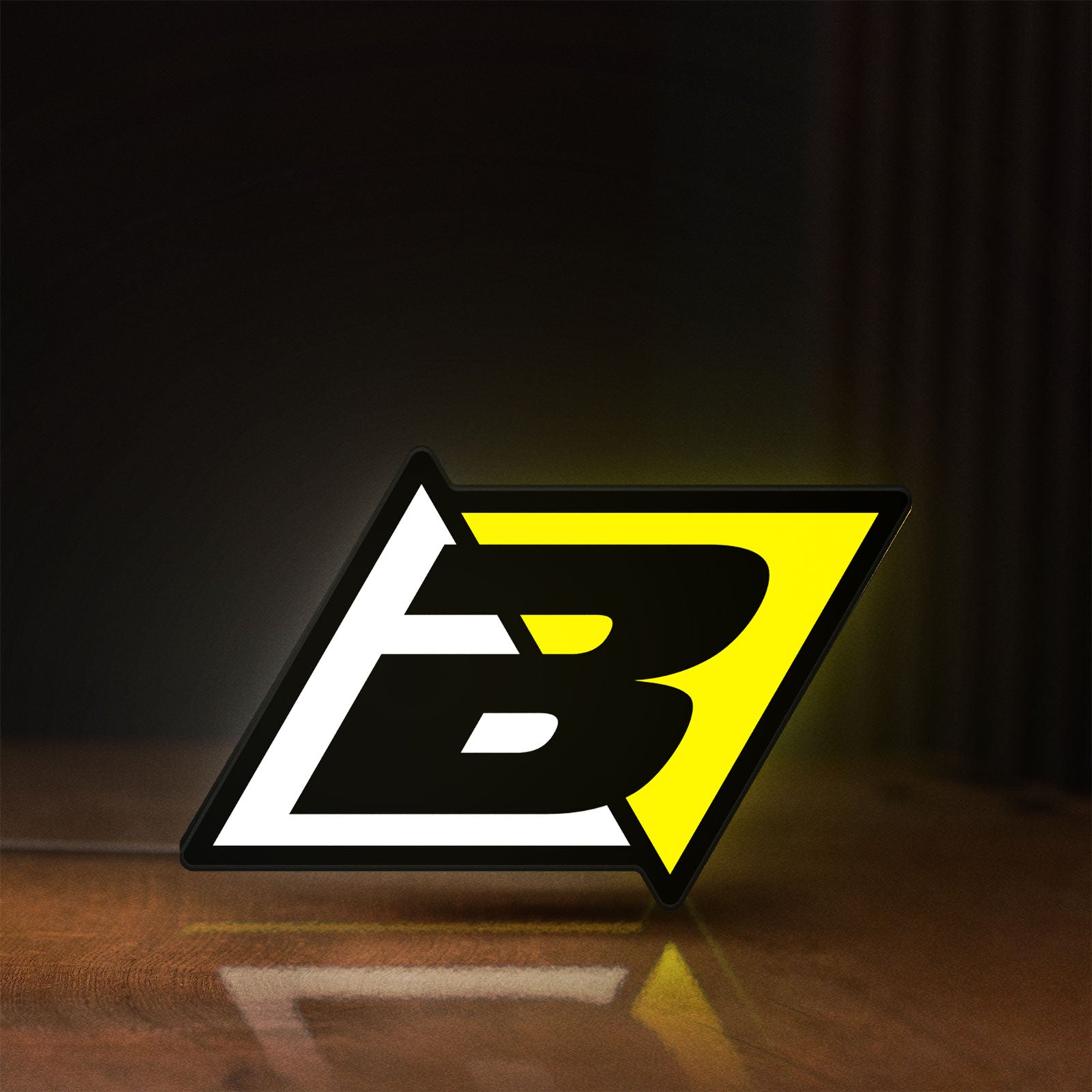 Front view of Blackbird Racing LED lightbox sign glowing on a wooden desk