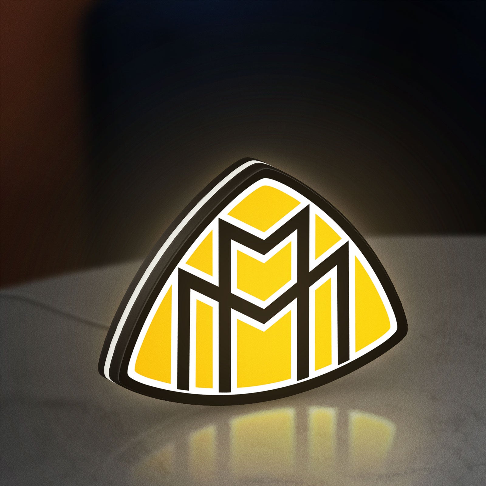 Maybach LED lightbox standing on a desk from an angled side view with white glow