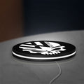 VW Volkswagen Skull LED lightbox lying flat on a desk with white glow