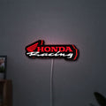 Honda Racing LED lightbox hanging on a wall with red glow
