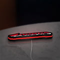 Honda Racing LED lightbox lying flat on a desk with red glow