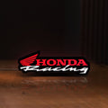 Front view of Honda Racing LED lightbox sign glowing on a wooden desk