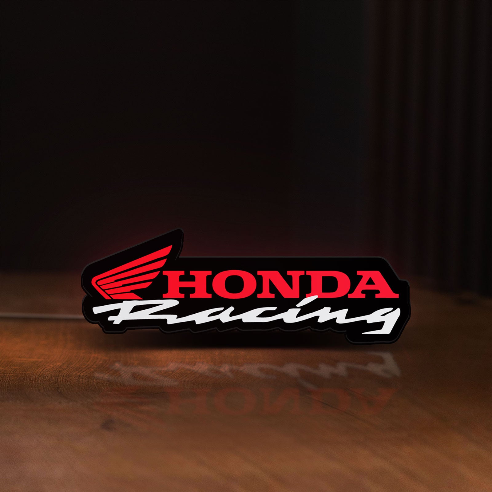 Front view of Honda Racing LED lightbox sign glowing on a wooden desk