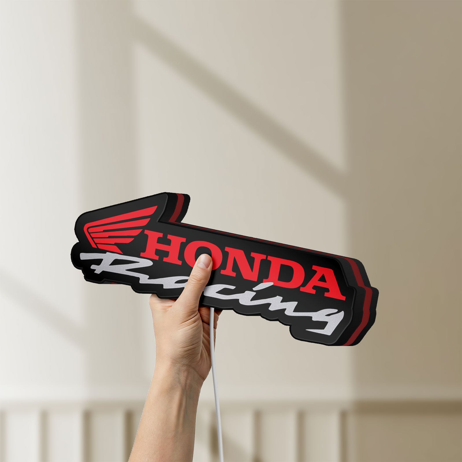 Unlit Honda Racing LED lightbox held by hand to show size and details