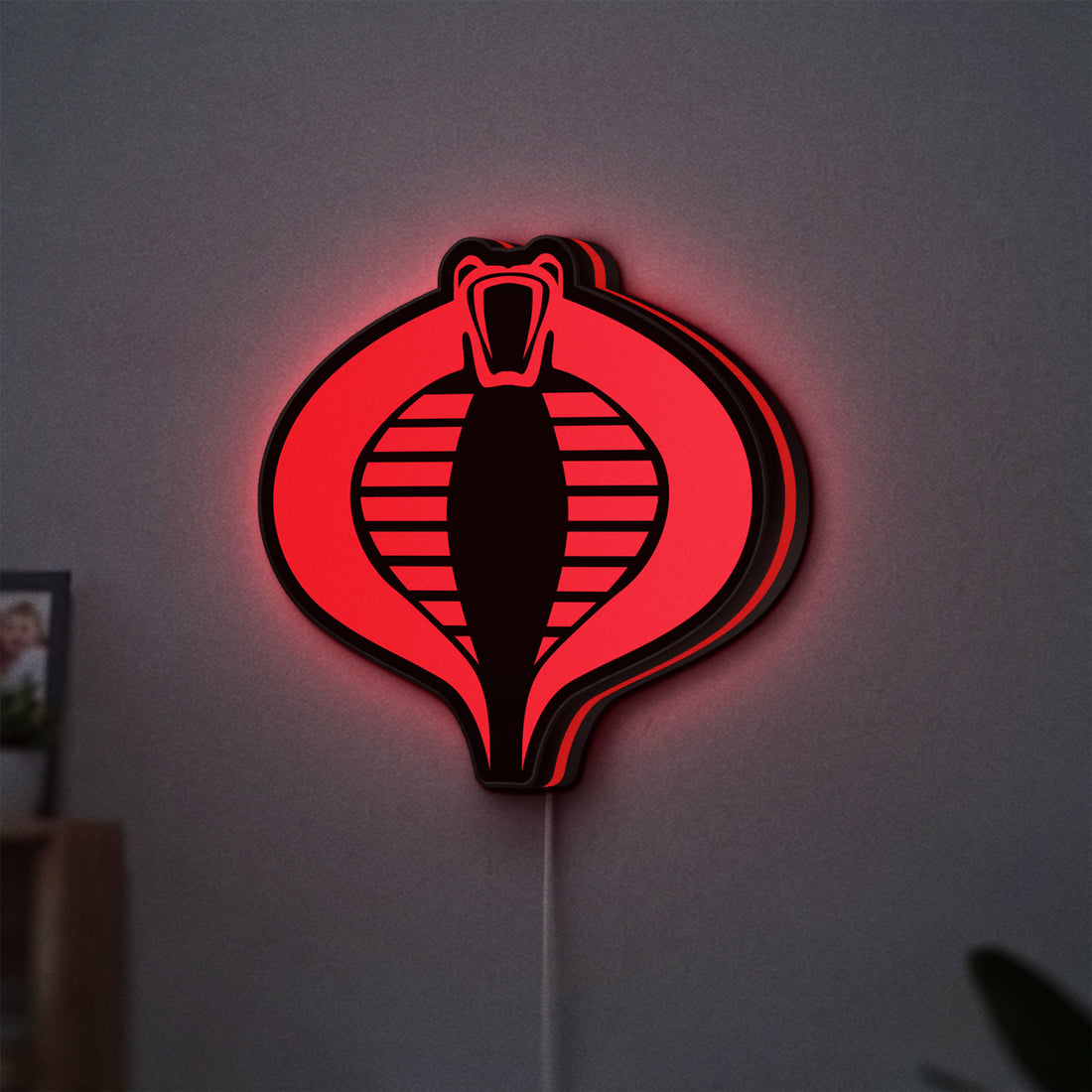 G.I. Joe Cobra LED lightbox hanging on a wall with red glow