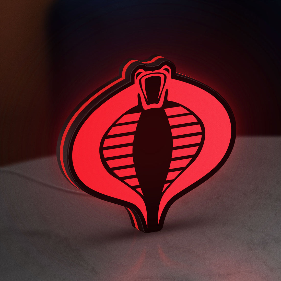 G.I. Joe Cobra LED lightbox hanging on a wall with red glow
