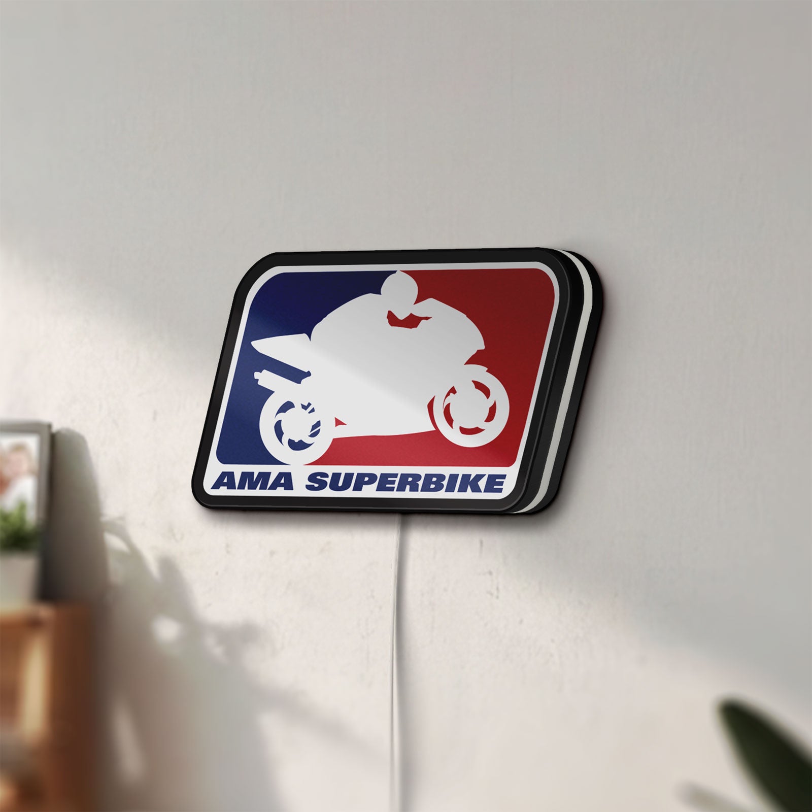 Unlit AMA Superbike LED lightbox mounted on a wall in daylight