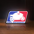 Front view of AMA Superbike LED lightbox sign glowing on a wooden desk