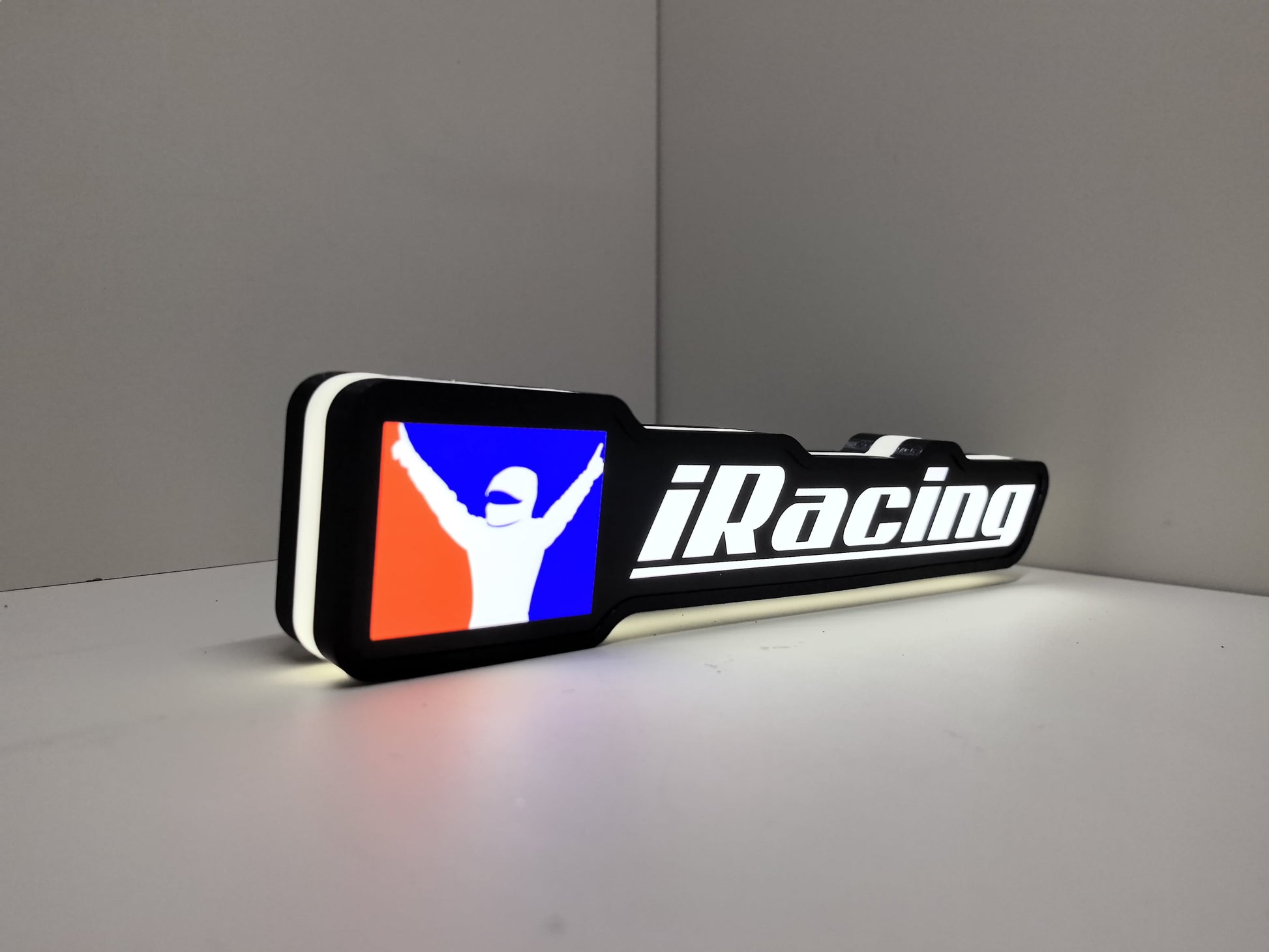 Illuminated angled view standing of Iracing Illuminated Sign in 30cm, perfect for garage and man cave decor