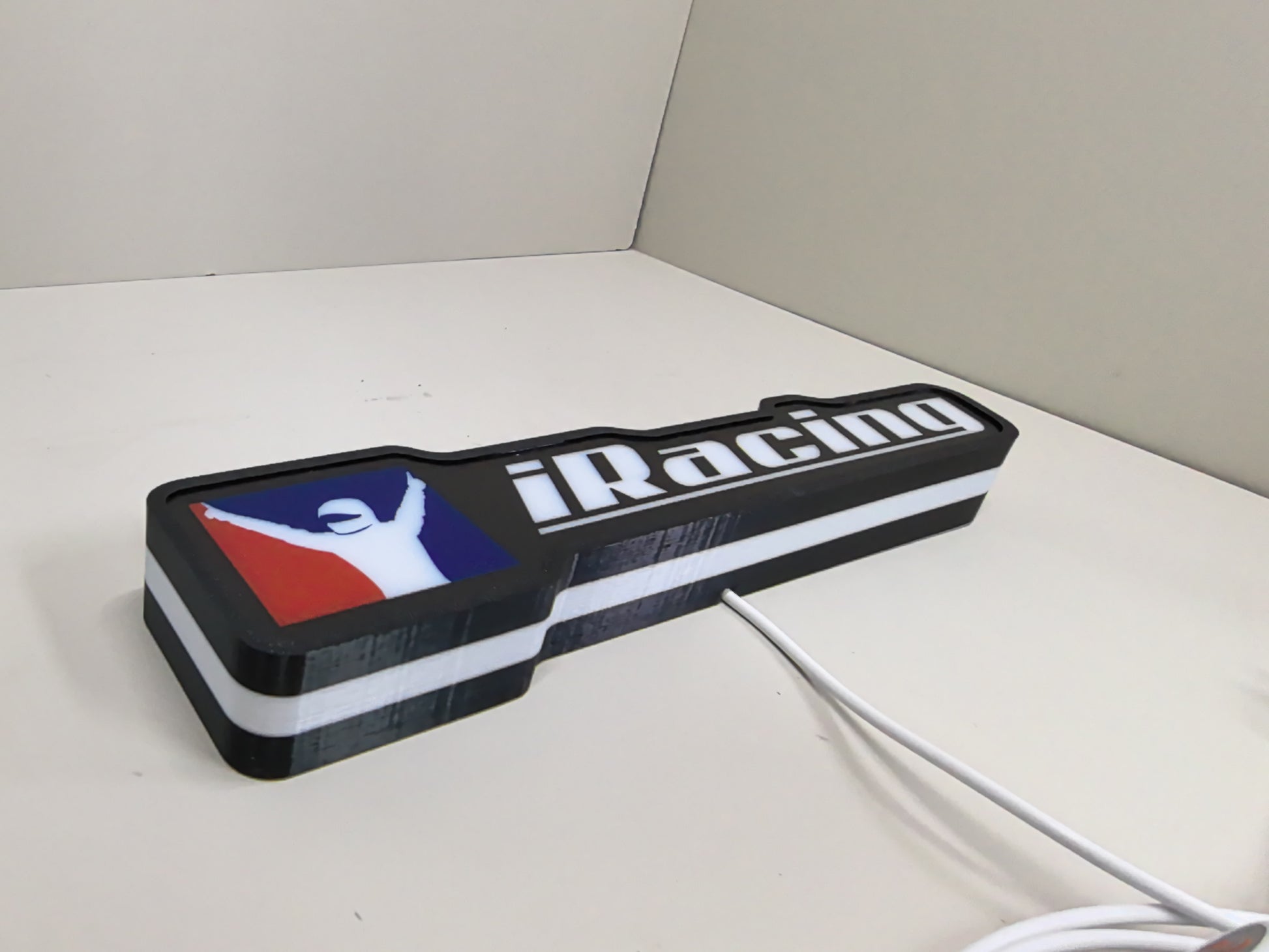 Unlit flat lay angled details of Iracing 3D LED Sign in 30cm, perfect for garage and man cave decor