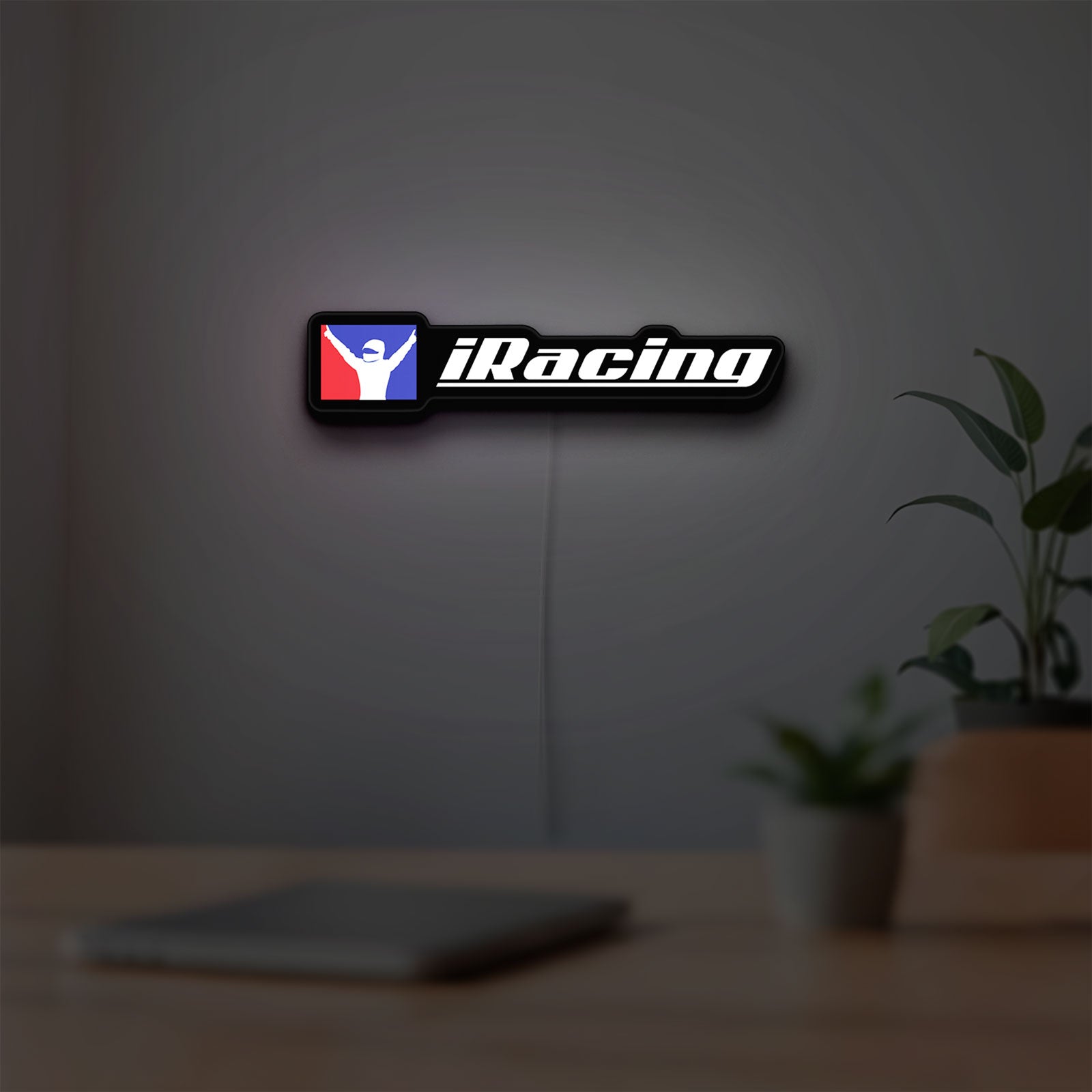iRacing LED lightbox hanging on a room wall with soft white light