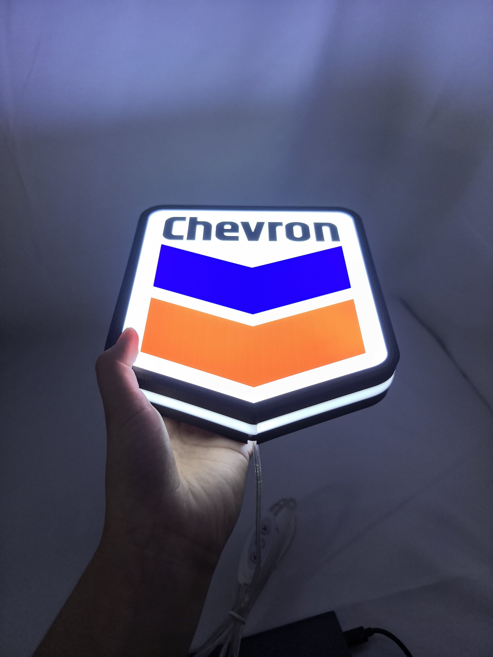 Illuminated handheld size reference of Chevron 3D LED Sign in 20cm, unique wall art for desk and room decor