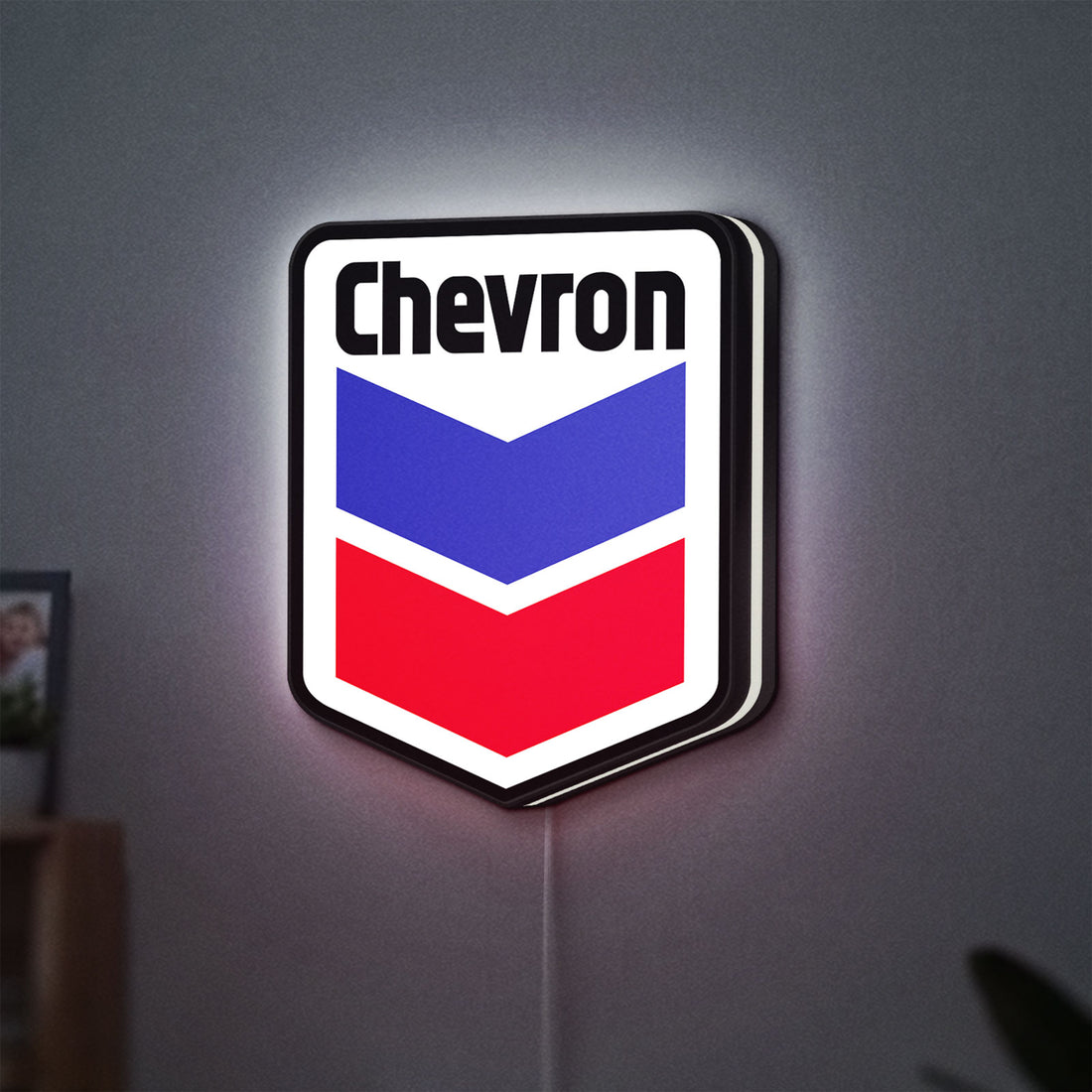 Chevron LED lightbox hanging on a wall with white glow