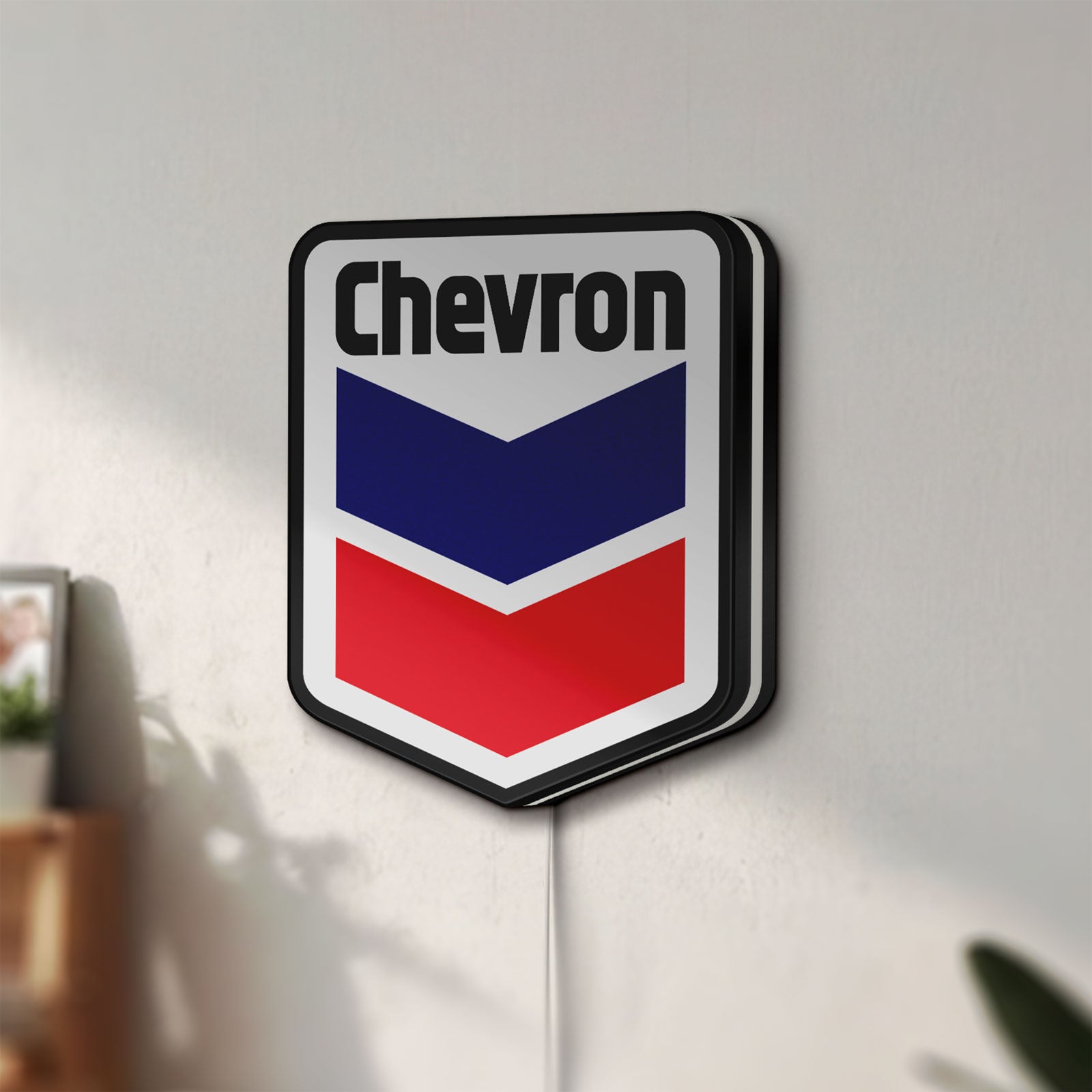 Unlit Chevron LED lightbox mounted on a wall in daylight