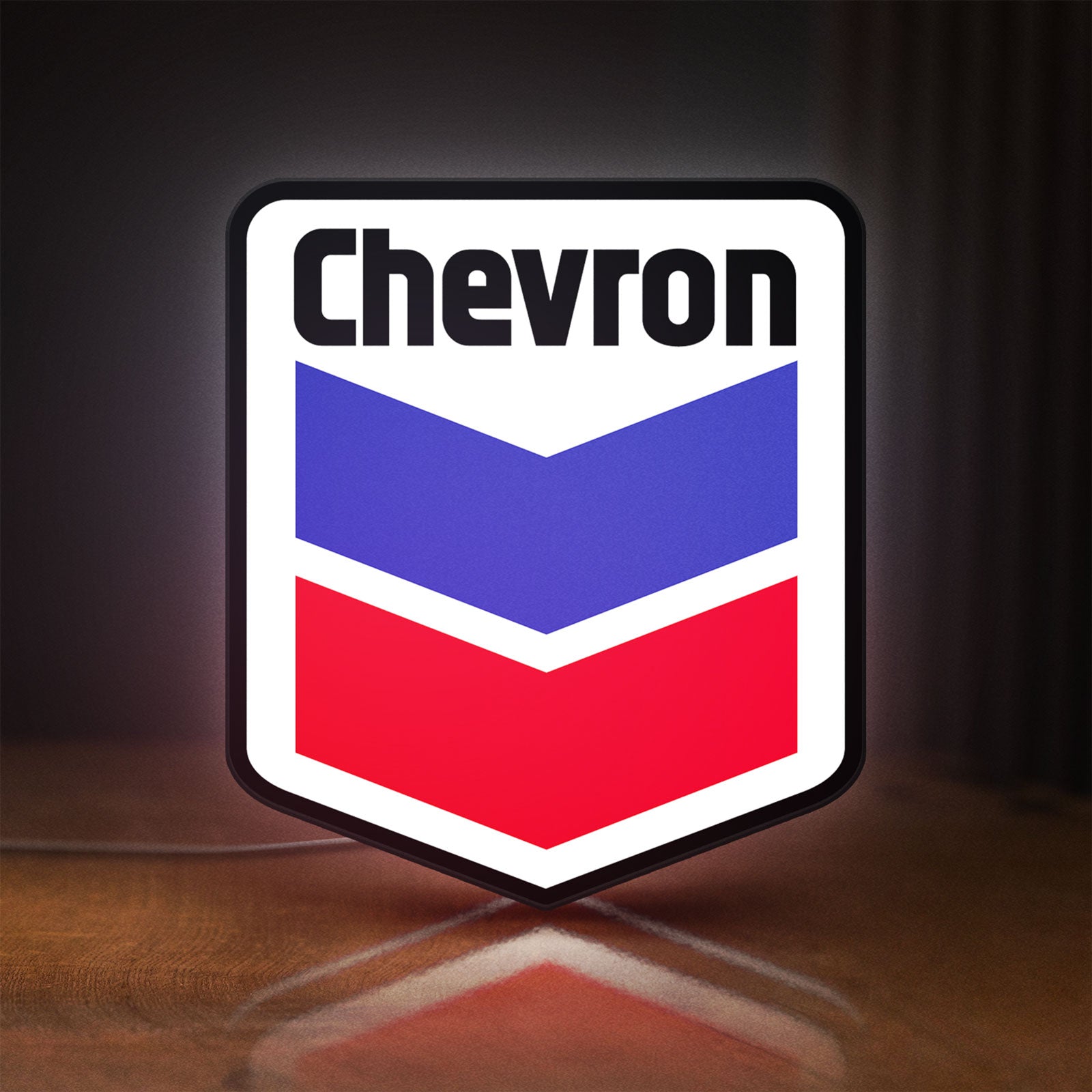 Front view of Chevron LED lightbox sign glowing on a wooden desk