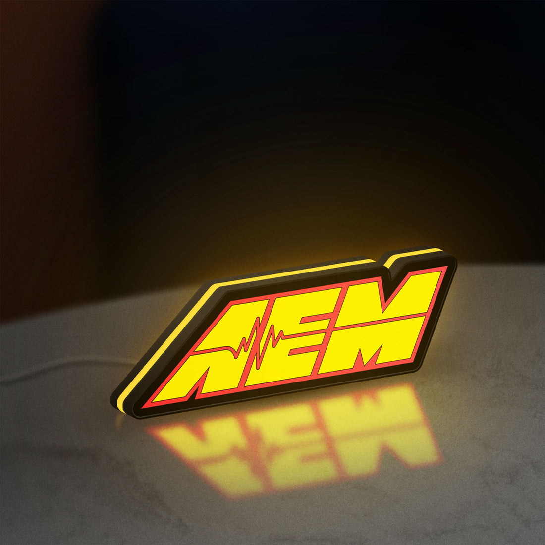 AEM Performance Electronics LED lightbox hanging on a wall with yellow glow