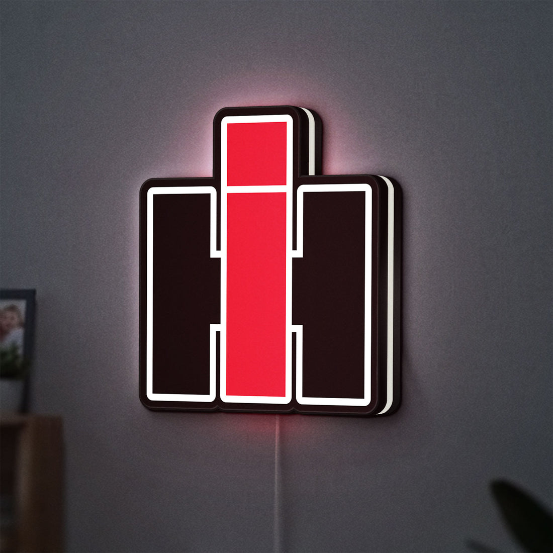 International Harvester LED lightbox hanging on a wall with white glow