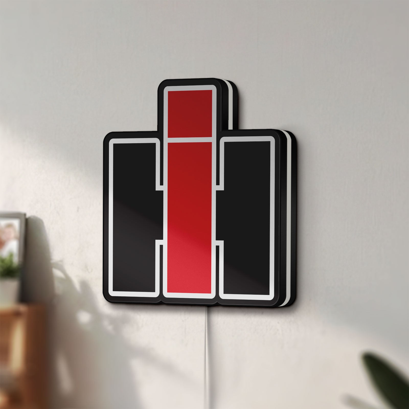 Unlit International Harvester LED lightbox mounted on a wall in daylight