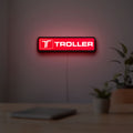 Troller LED lightbox hanging on a room wall with soft red light