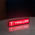 Troller LED lightbox standing on a desk from an angled side view with red glow