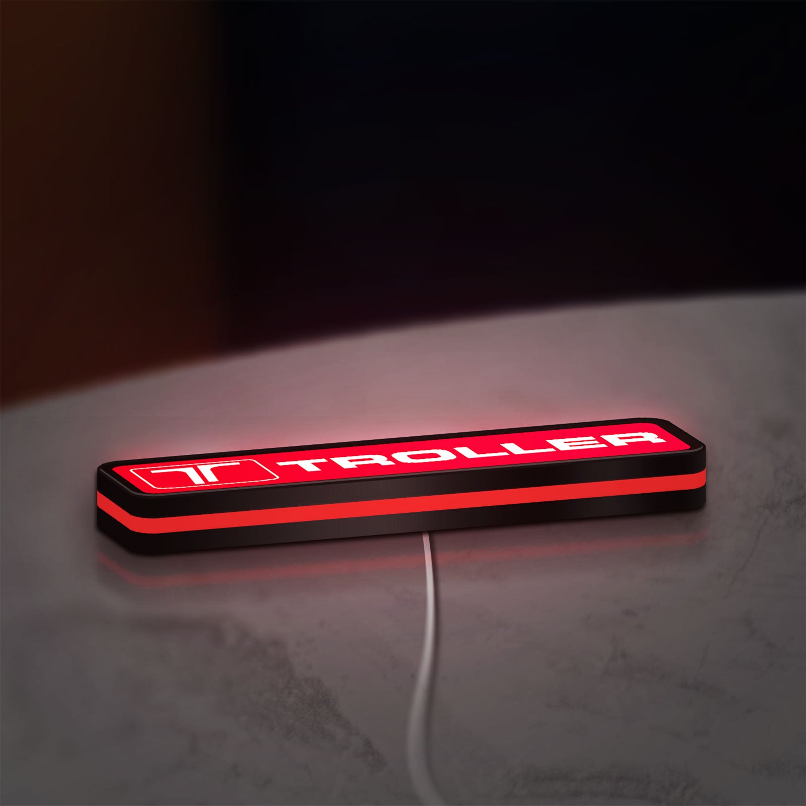 Troller LED lightbox lying flat on a desk with red glow