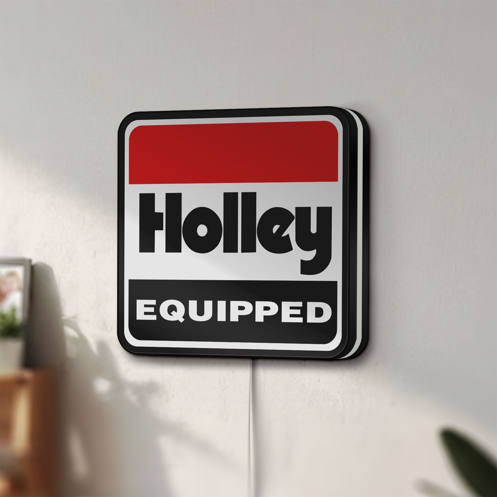 Unlit Holley Equipped LED lightbox mounted on a wall in daylight