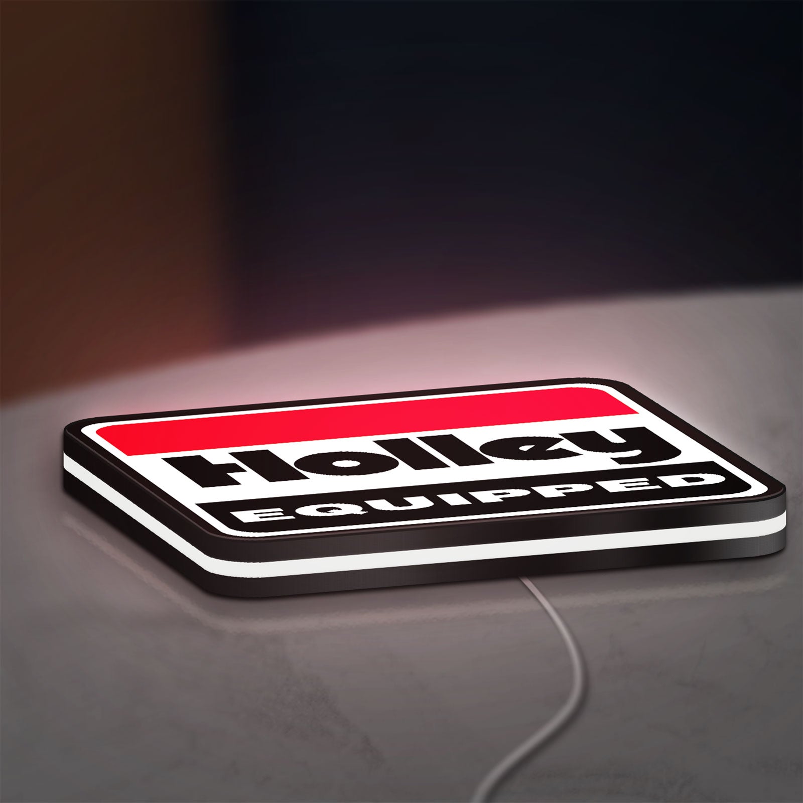 Holley Equipped LED lightbox lying flat on a desk with white glow