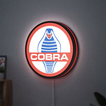Cobra LED lightbox hanging on a wall with red glow