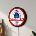 Unlit Cobra LED lightbox mounted on a wall in daylight