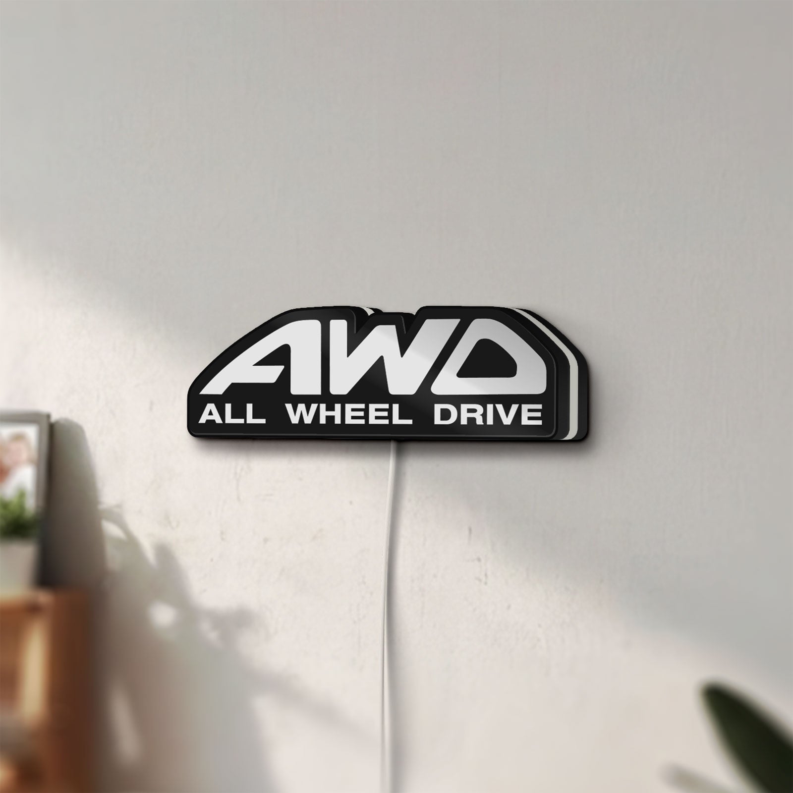 Unlit AWD LED lightbox mounted on a wall in daylight