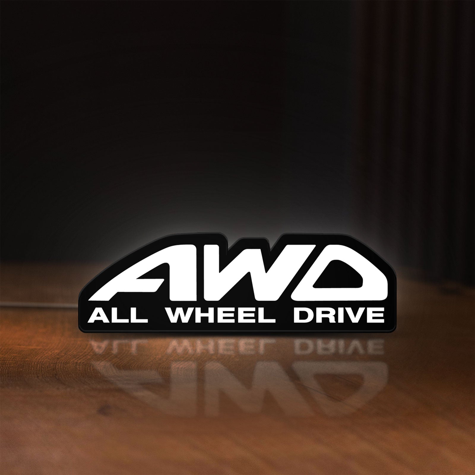 Front view of AWD LED lightbox sign glowing on a wooden desk