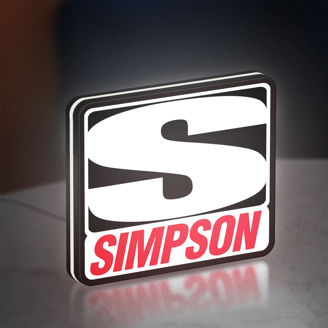 Simpson Racing LED lightbox hanging on a wall with white glow