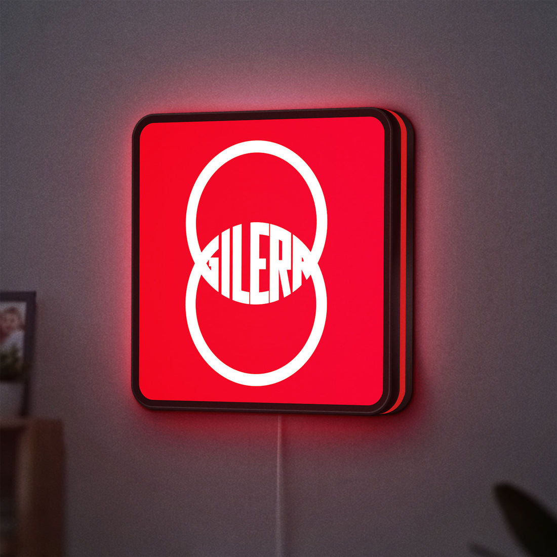 Gilera LED lightbox hanging on a wall with red glow