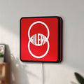 Unlit Gilera LED lightbox mounted on a wall in daylight