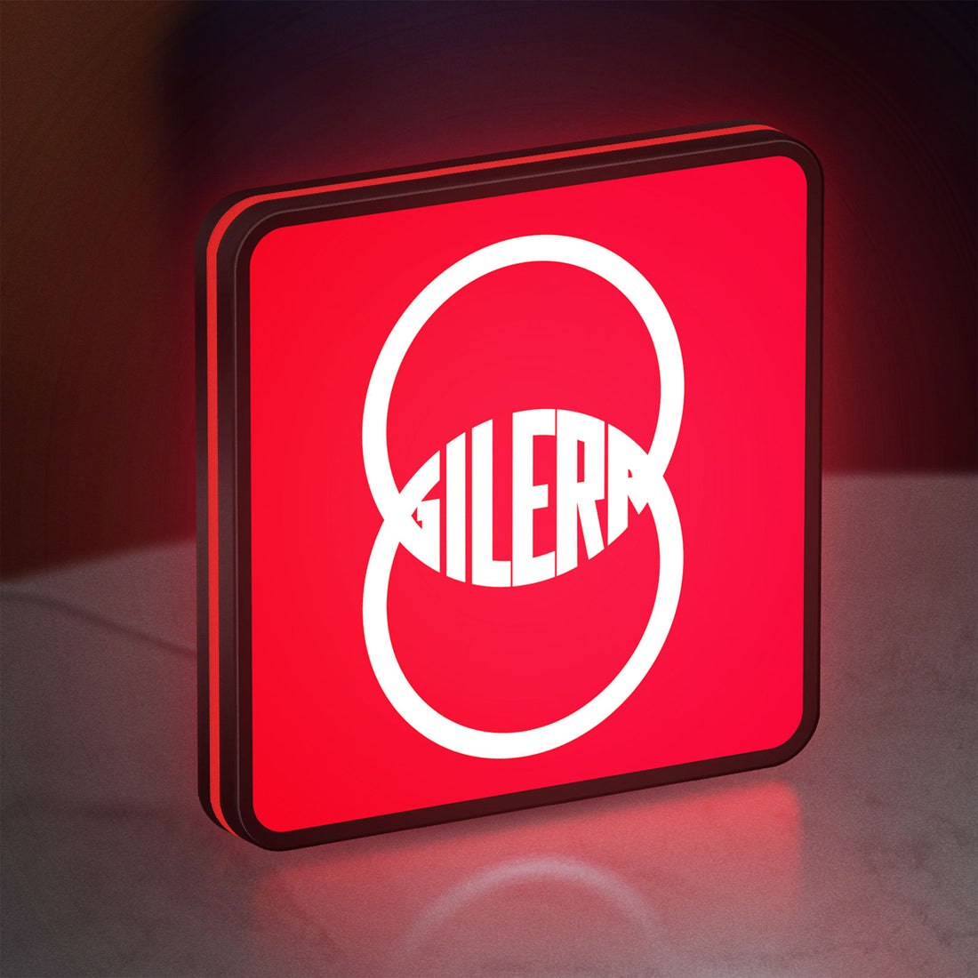 Gilera LED lightbox hanging on a wall with red glow
