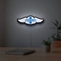 Morgan Motors LED lightbox hanging on a room wall with soft white light