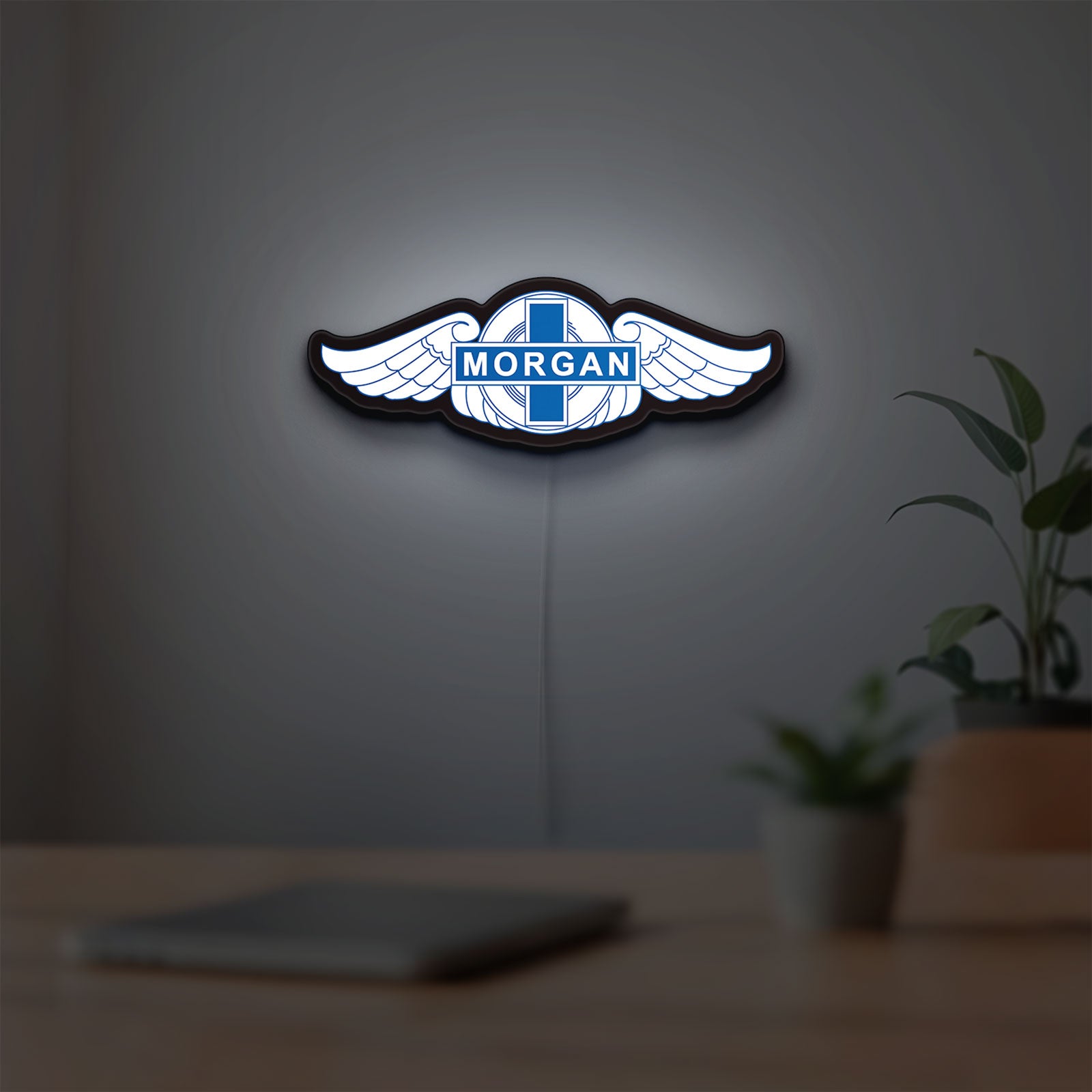 Morgan Motors LED lightbox hanging on a room wall with soft white light