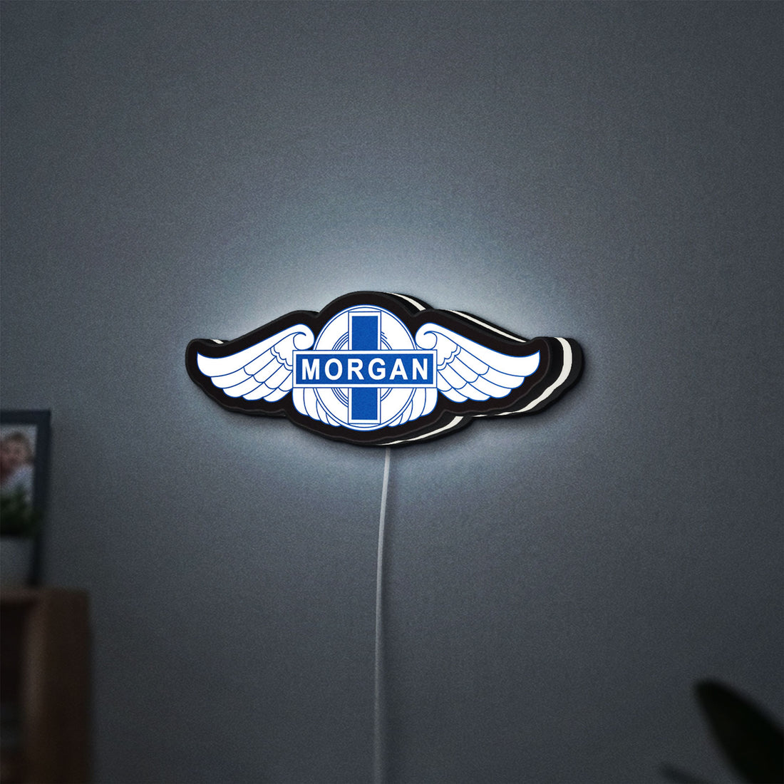 Morgan Motors LED lightbox hanging on a wall with white glow