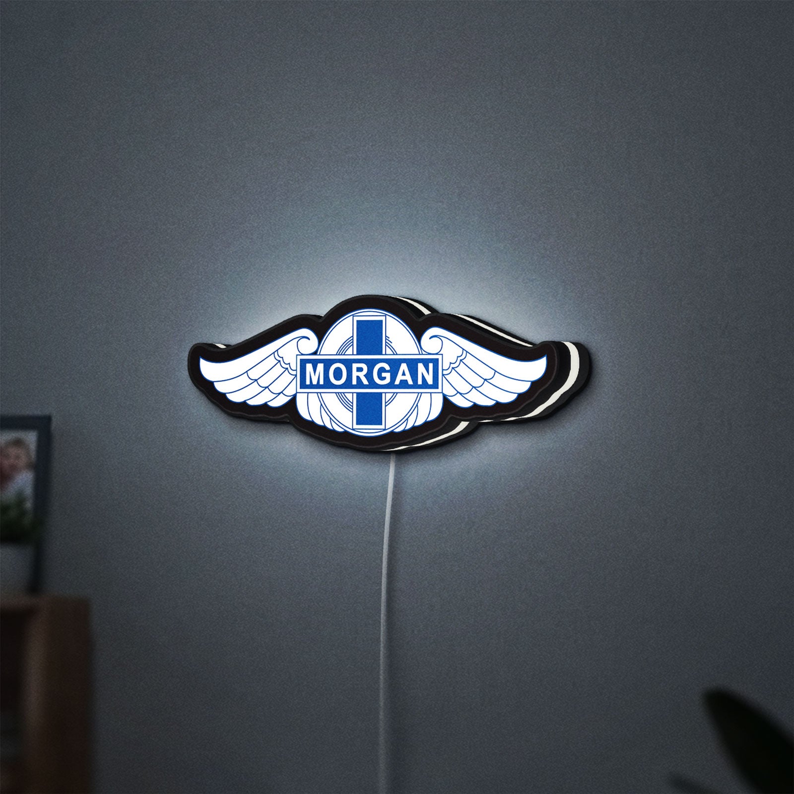 Morgan Motors LED lightbox hanging on a wall with white glow