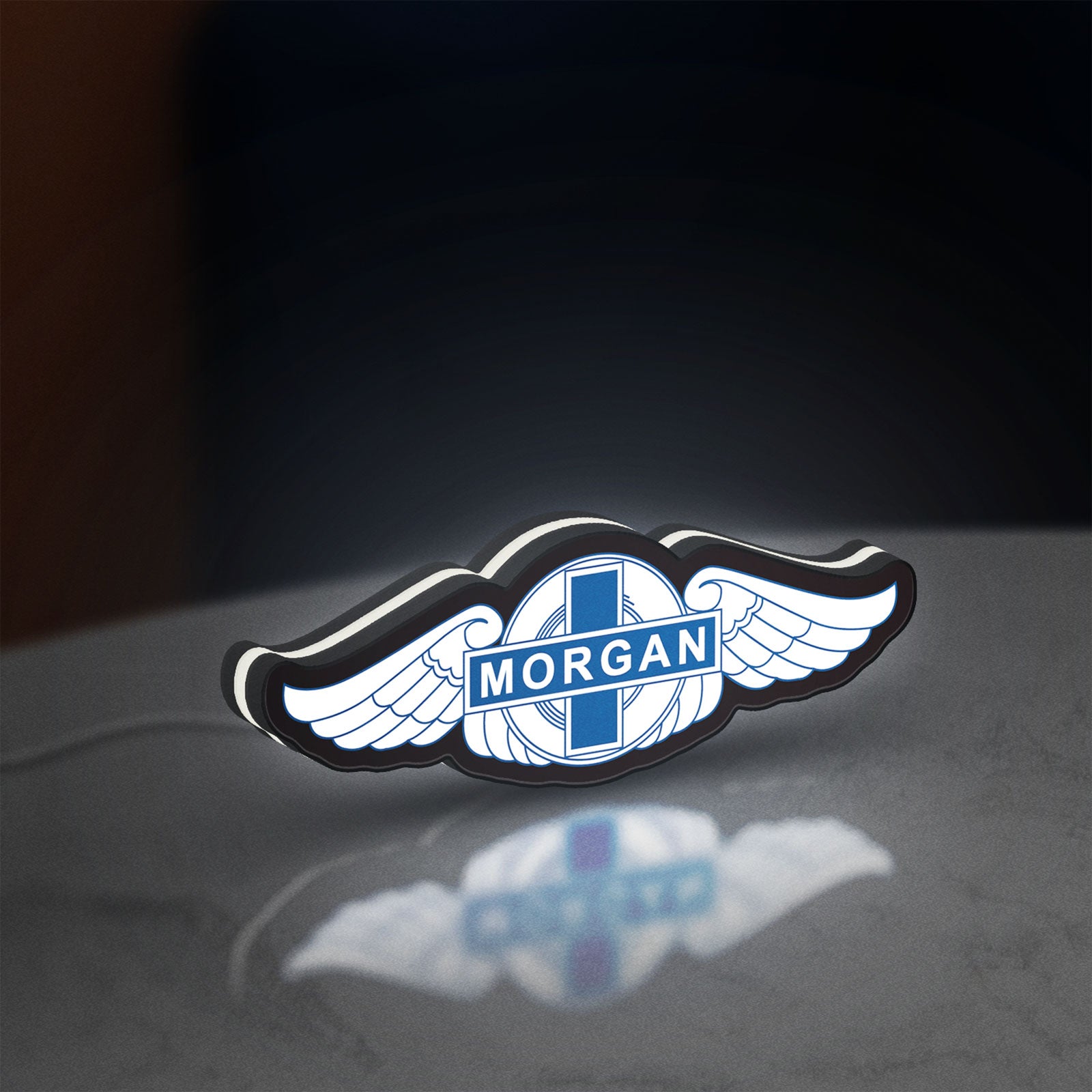 Morgan Motors LED lightbox standing on a desk from an angled side view with white glow