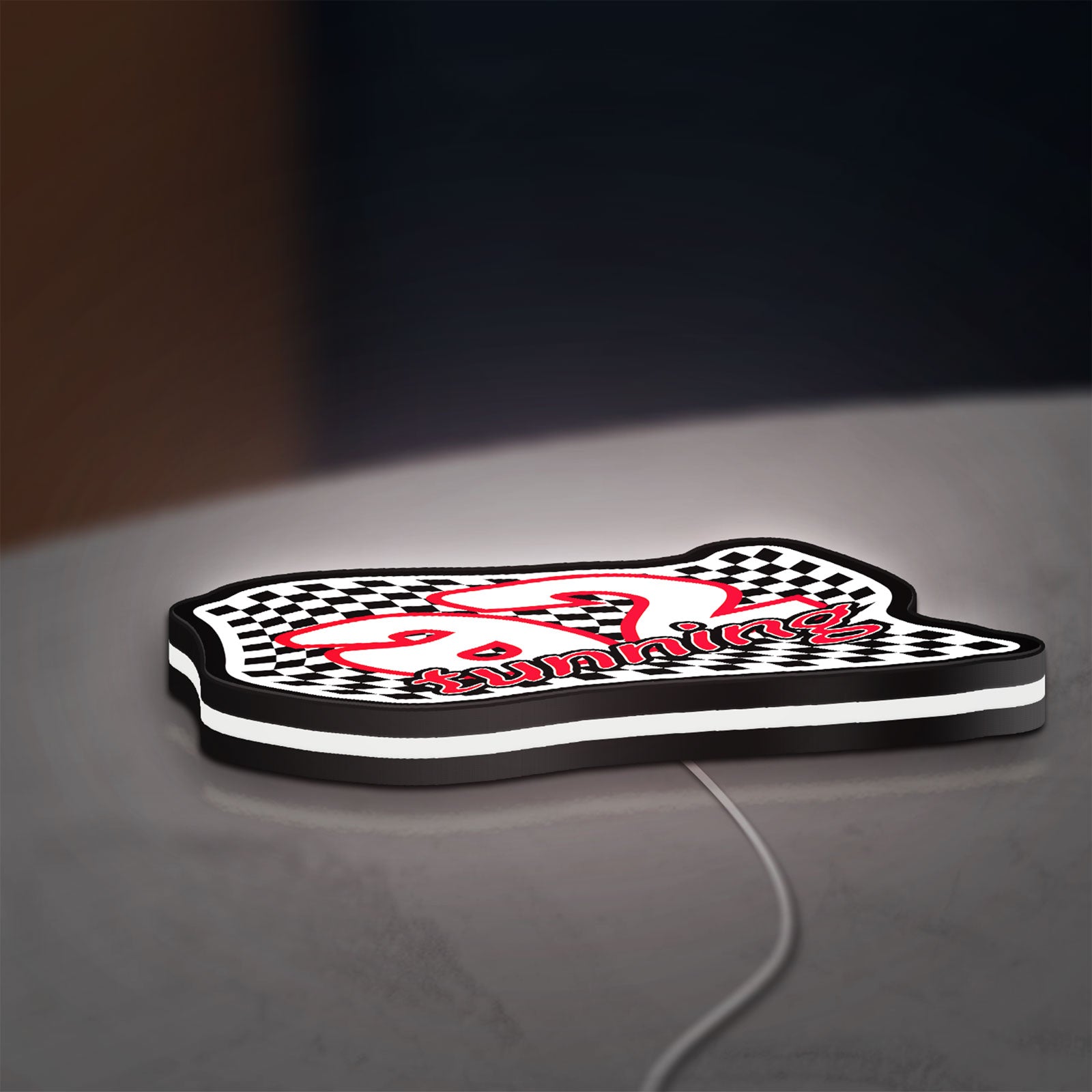 A2 Tuning LED lightbox lying flat on a desk with white glow