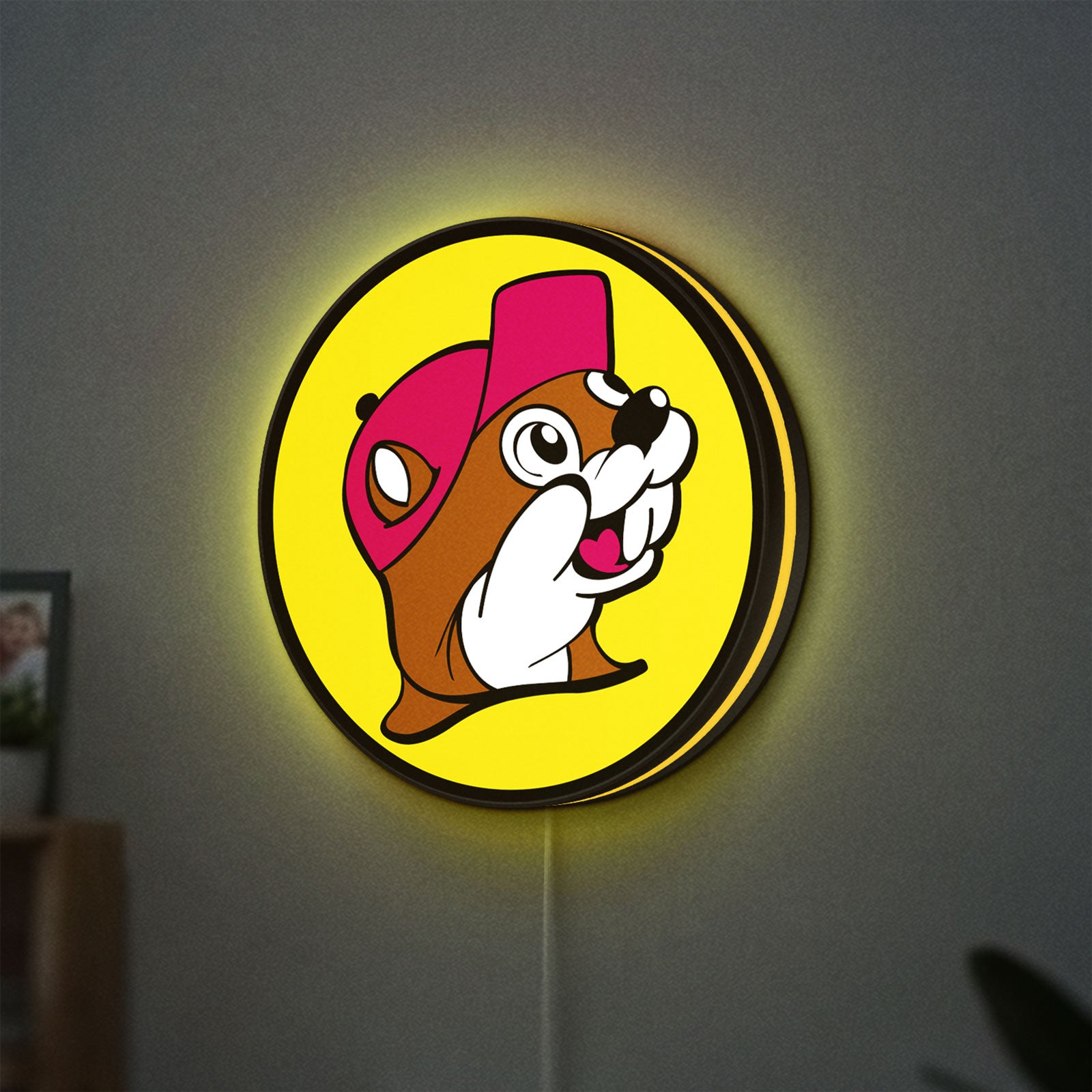 Buc-ee's Beaver Mascot LED lightbox hanging on a wall with yellow glow