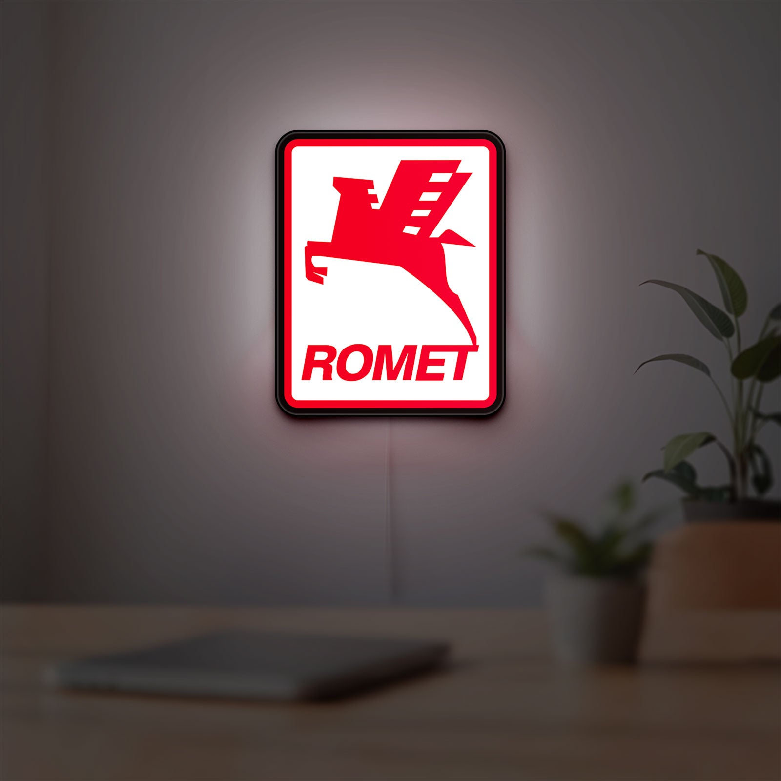 Romet Sign LED lightbox hanging on a room wall with soft red light