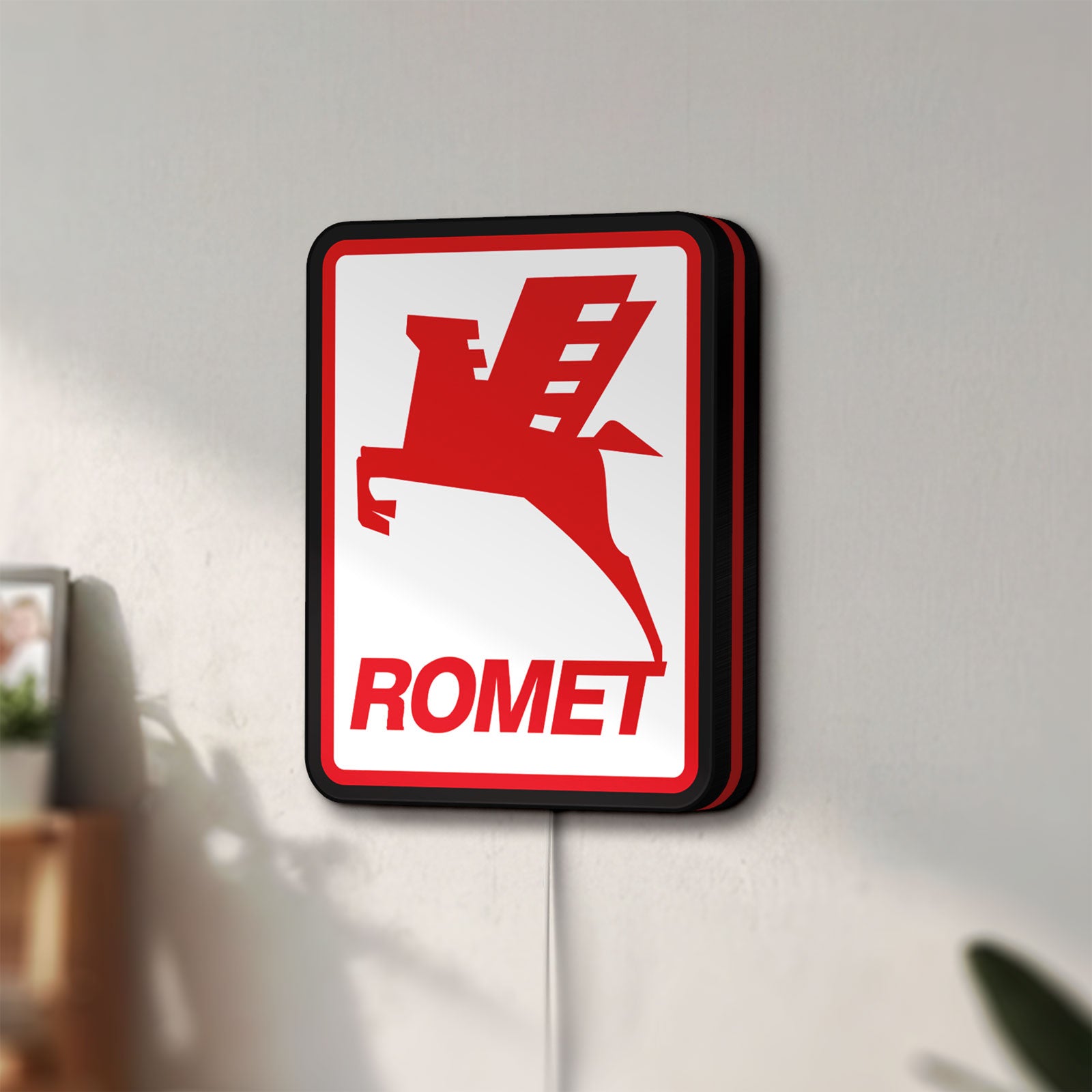 Unlit Romet Sign LED lightbox mounted on a wall in daylight