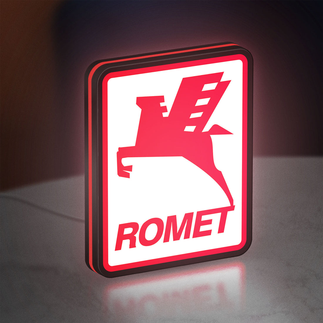 Romet Sign LED lightbox hanging on a wall with red glow
