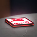 Romet Sign LED lightbox lying flat on a desk with red glow
