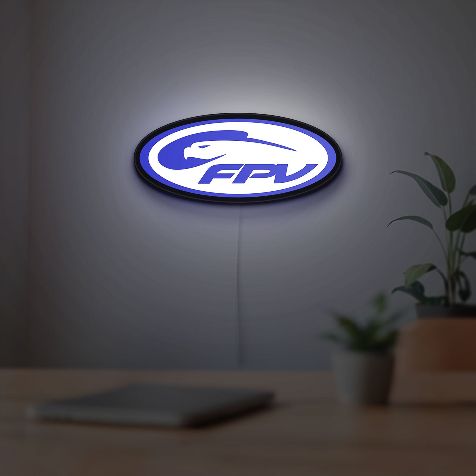 FPV Drone Pilot Gift LED lightbox hanging on a room wall with soft blue light