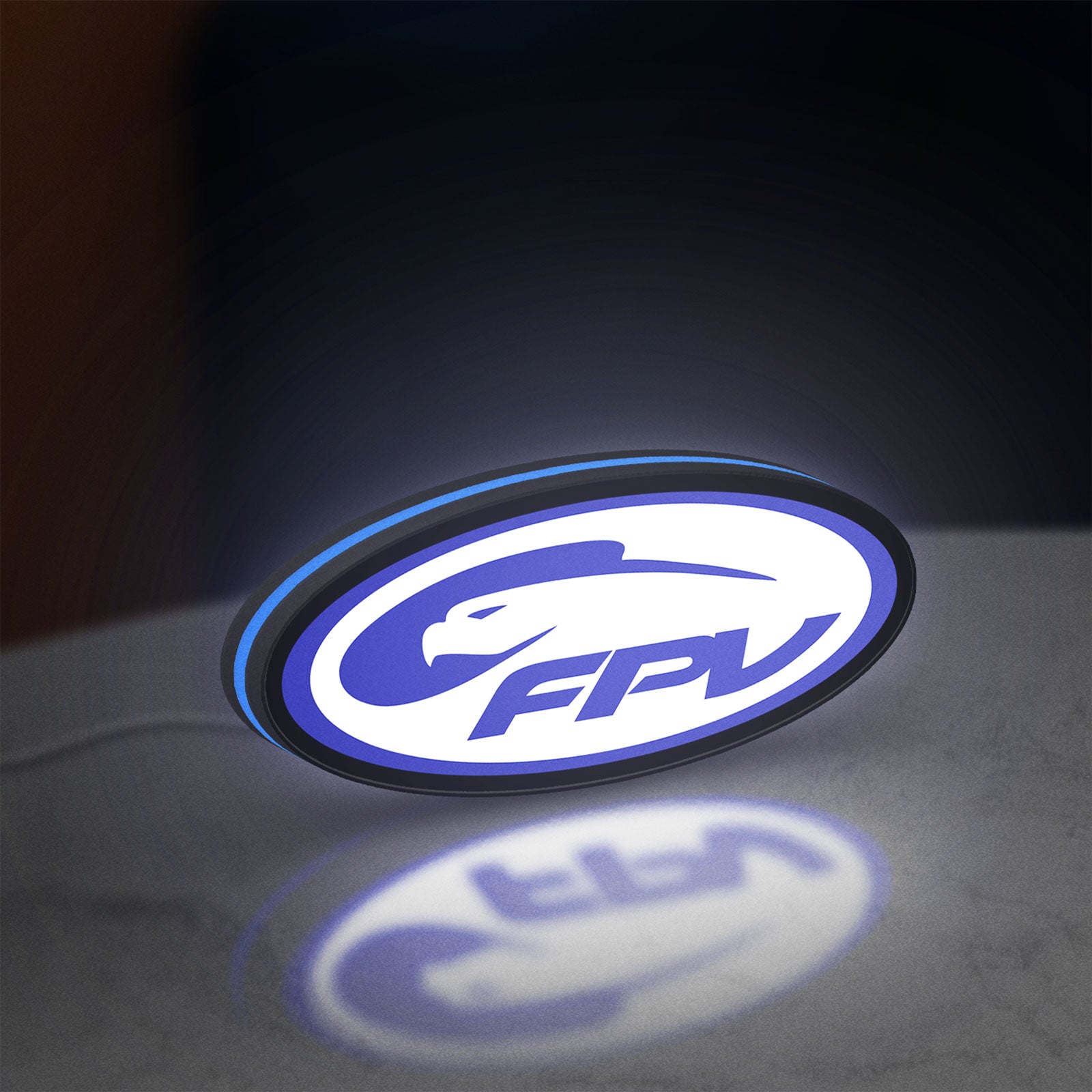 FPV Drone Pilot Gift LED lightbox standing on a desk from an angled side view with blue glow
