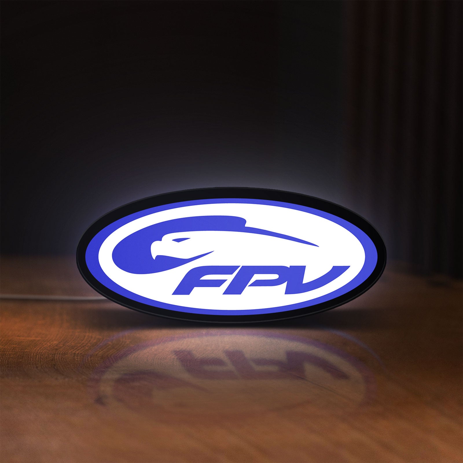 Front view of FPV Drone Pilot Gift LED lightbox sign glowing on a wooden desk