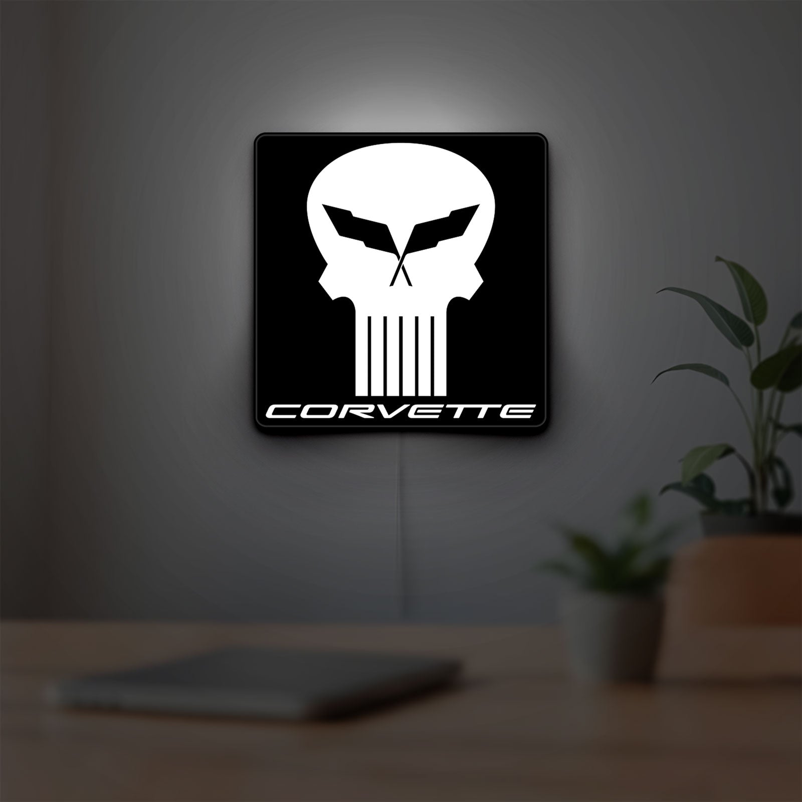 Corvette Skull LED lightbox hanging on a room wall with soft white light